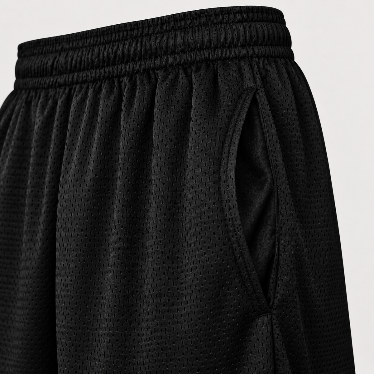 Close view of Black East Islip mesh shorts side-entry pocket and elastic waistband