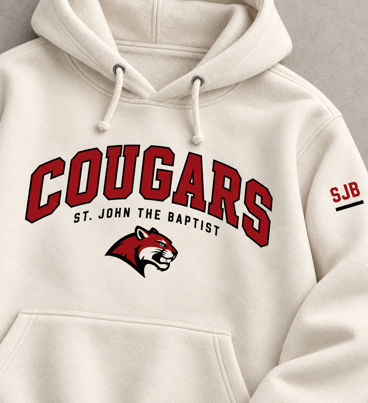 Close view of red and black Cougars chest and SJB sleeve prints on Bone hoodie